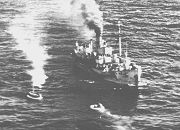 The Royal Navy minesweeper HMS Flanders arrives at the crash site